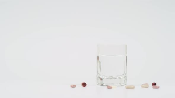 Throwing pills near a glass of water alt