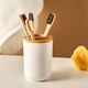 Bamboo toothbrushes in a cup and a towel in a bathroom interior. - PhotoDune Item for Sale