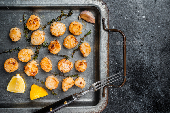 Scallops Poached In A Butter And Garlic Sauce In A Steel Tray With Thyme Black Background Top 4368