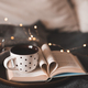 Cup of tea with book in bed - PhotoDune Item for Sale