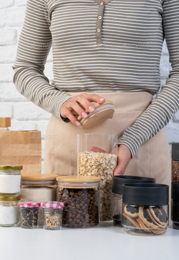 woman Reusing Glass Jars To Store Dried Food Living Sustainable