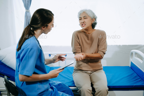 Friendly Female Head Nurse Making Rounds does Checkup on Patient Resting in Bed. She Checks tablet