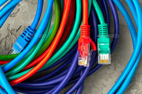 Colored network cable patch-cord on gray textured background