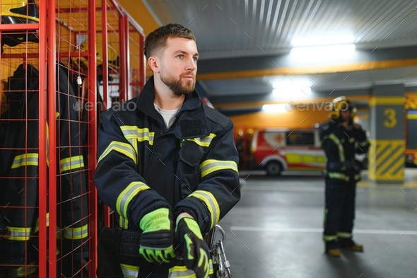 A firefighter puts on a fire uniform at the fire department Stock Photo ...