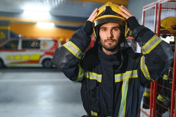 A firefighter puts on a fire uniform at the fire department Stock Photo ...