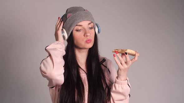 Young Caucasian Woman with Tail Eating Piece of Pizza