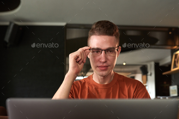 Man Reading E-mails on Laptop