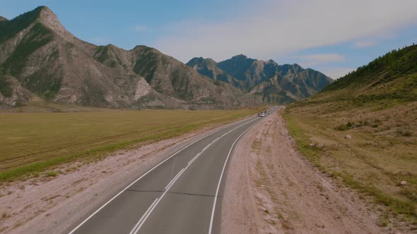 Chuya highway in mountains valley of Altai with traffic cars