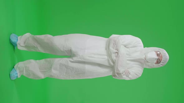 Male Wear Protective Uniform PPE Pose With Arms Crossed In Green Screen Studio alt