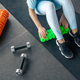 Sport woman using foam roller for muscle and fascia stretching foot. Stock  Photo by puhimec