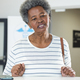 African american senior woman with smartphone in hospital reception - PhotoDune Item for Sale