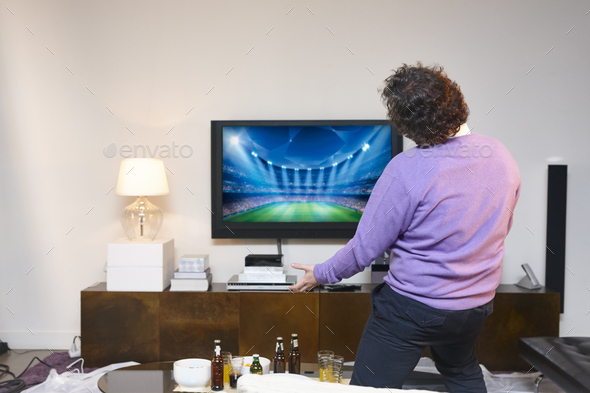 Man celebrating a tv football game. Home entertainment. Betting
