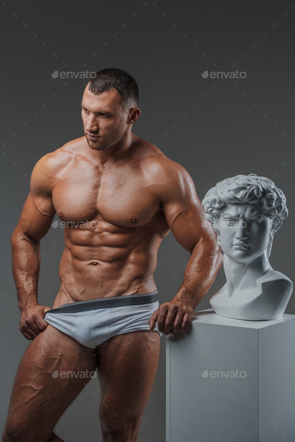 Rugged Beauty: Muscular Man and Ancient Greek Statues