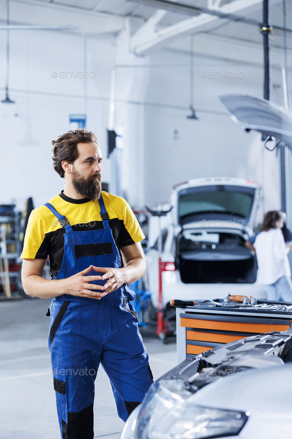Engineer checks car specs with AR Stock Photo by DC_Studio PhotoDune