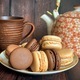 Delicious macaron cookies and tea on wooden background  - PhotoDune Item for Sale