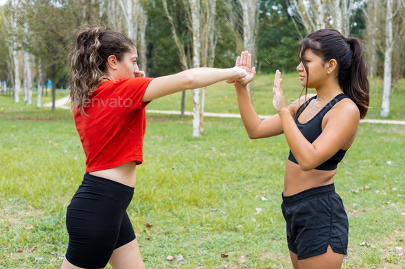 Female boxers training boxing sparring and punching outdoors