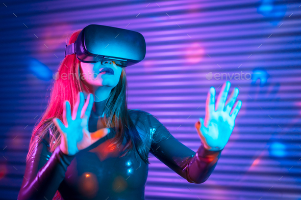 Blonde woman during an interactive game with VR goggles