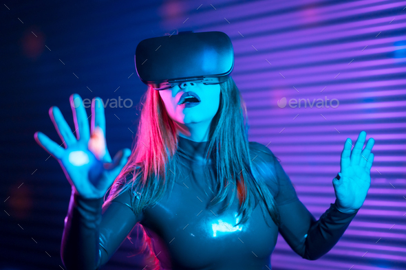 Surprised woman during an interactive game with Virtual Reality goggles