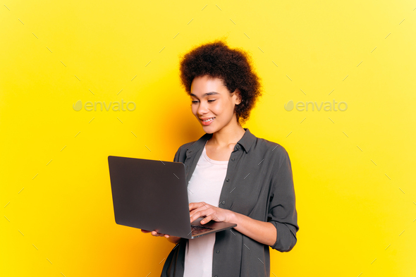Positive african american or brazilian young woman, female student, programmer, freelancer, web
