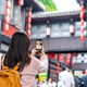 Young female tourist taking a photo of the Jinli Ancient Street in Chengdu, China - PhotoDune Item for Sale