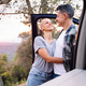 woman and man embracing next to their camper van - PhotoDune Item for Sale