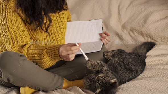 unrecognizable woman makes notes in a notebook. Hand writes.. Woman makes plans for the future
