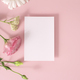 Greeting card mockup and flowers on pink background top view flatlay. Card mock-up with copy space. - PhotoDune Item for Sale