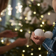 Girl holding Christmas balls and Christmas tree in the background - PhotoDune Item for Sale