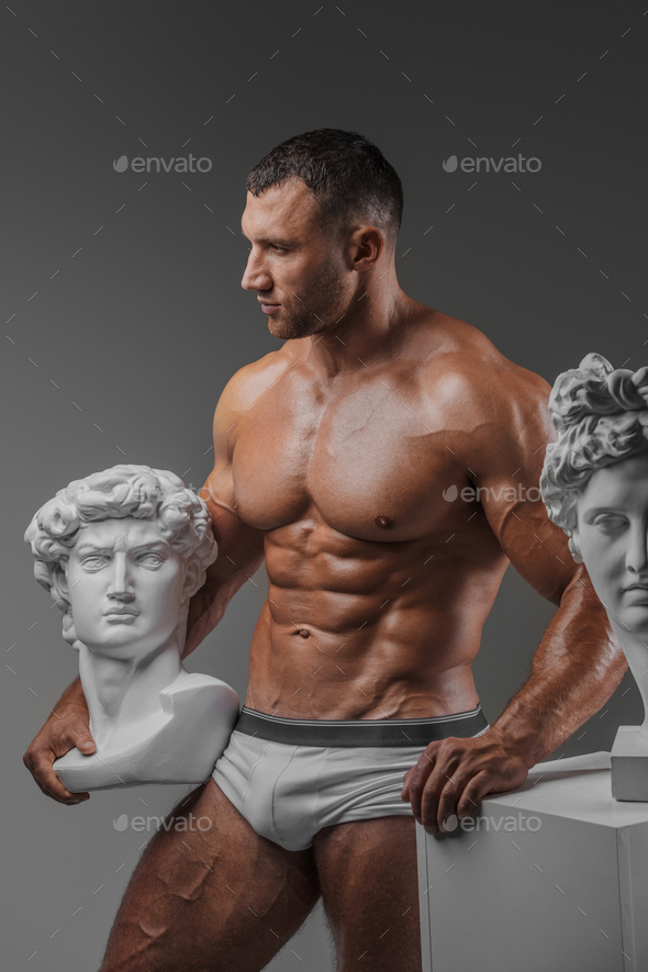 Rugged Beauty: Muscular Man and Ancient Greek Statues
