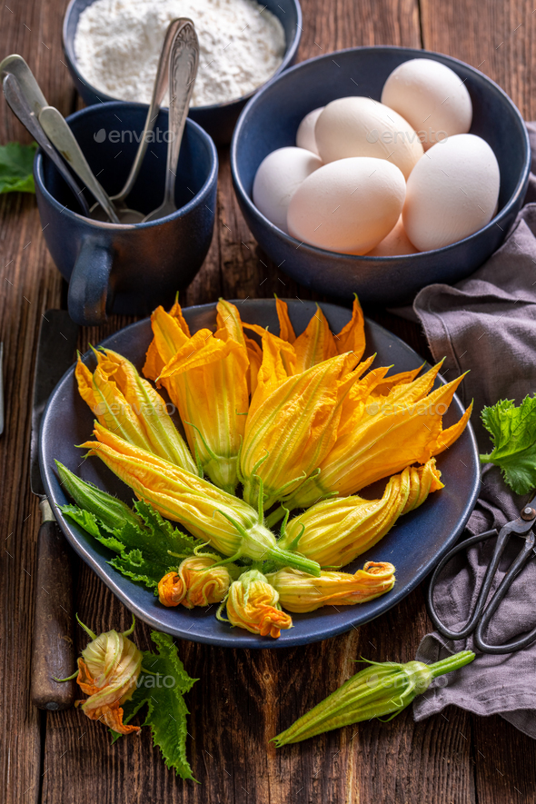 Preparation for fried zucchini flower made of pancake batter. Stock