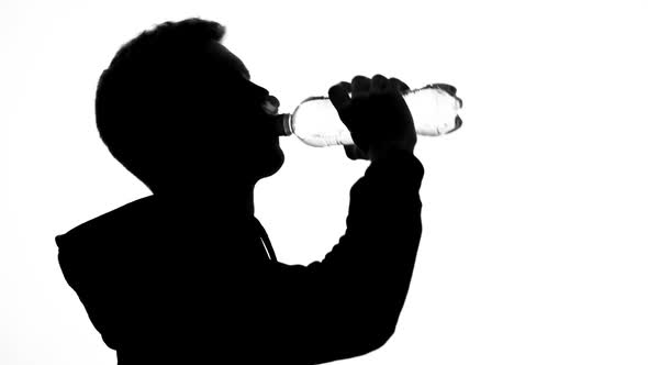 Male Runner Shadow Drinking Water From Bottle, Healthy Lifestyle, Nutrition alt