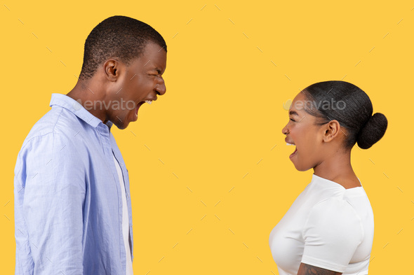 Black man and woman shouting loudly at each other, side view