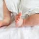 Small feet of a newborn baby. The concept of motherhood, breastfeeding. - PhotoDune Item for Sale