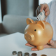 Accountant is putting money into a piggy bank, Financier is bringing savings methods to clients who  - PhotoDune Item for Sale