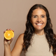 Happy caucasian senior woman with perfect skin care, show orange fruit - PhotoDune Item for Sale