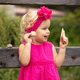 A little girl in a pink dress is cheerful with cookies in her hands - PhotoDune Item for Sale