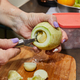 Chef cuts out the inside of zucchini for stuffing in home kitchen - PhotoDune Item for Sale