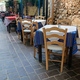 Outdoors traditional tavern restaurant Chania Old Town, Crete island Greece. Potted plant on alley. - PhotoDune Item for Sale