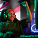 Smiling African American Woman as Gamer Celebrating Victory in Neon Lighting - PhotoDune Item for Sale