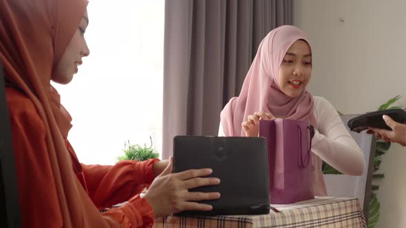Asian Muslim Woman Using Smartwatch Payment alt