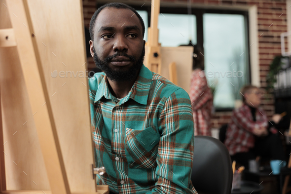 Black guy learning to draw in art studio