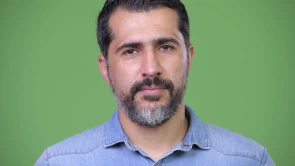 Handsome Persian Bearded Man Against Green Background
