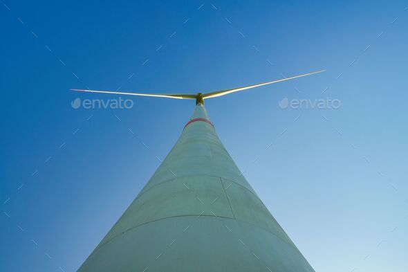 Low-angle shot of a wind power turbine for a green future with renewable energy on a sky background