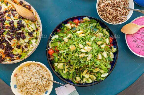 Variety of salad bowls, beet sauce, quinoa and brown rice.