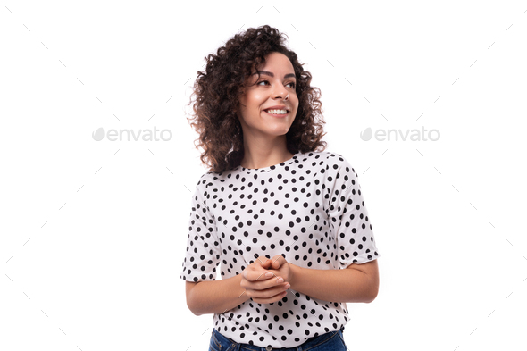 young leader woman with curly hairstyle dressed in summer blouse with polka dot print feels