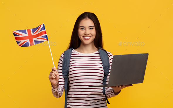 Cute asian woman student with laptop and flag of GB
