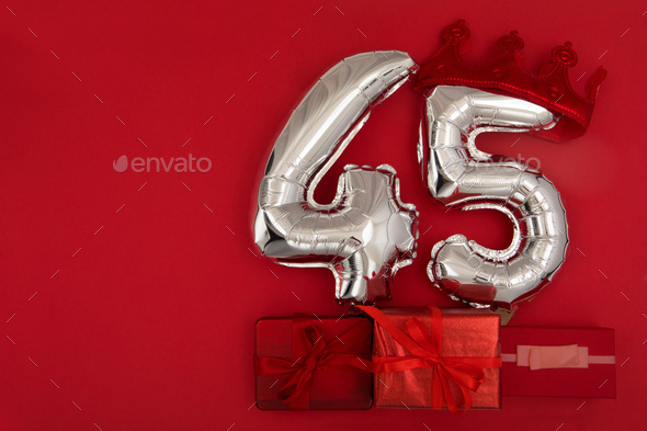 Balloon 45 in crown on dark red background flat lay