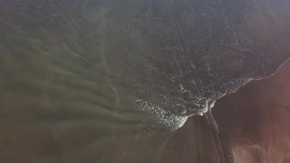 Aerial View Of Beach Waves Splashing In Maharashtra, India. drone shot alt