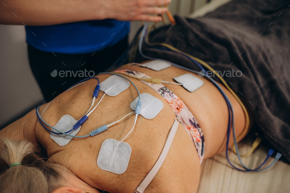 Lower Back Physical Therapy with TENS Electrode Pads, Transcutaneous Electrical Nerve Stimulation.