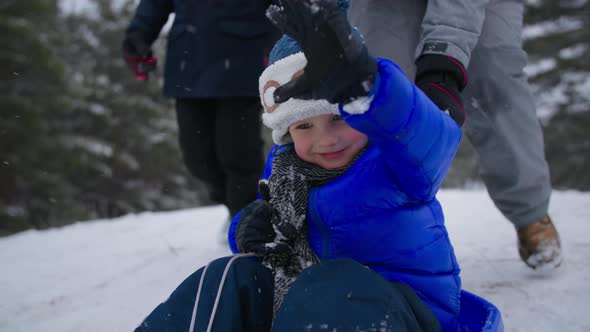 Trouble Happens Adorable Male Kid Sledding with Mom And Brother Then Falls on the Snow During a Hill